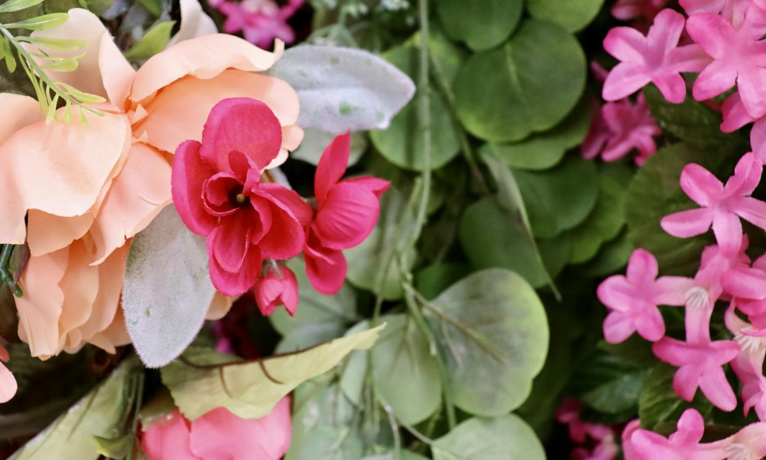 Professional floral arrangement workspace showing various tools and techniques